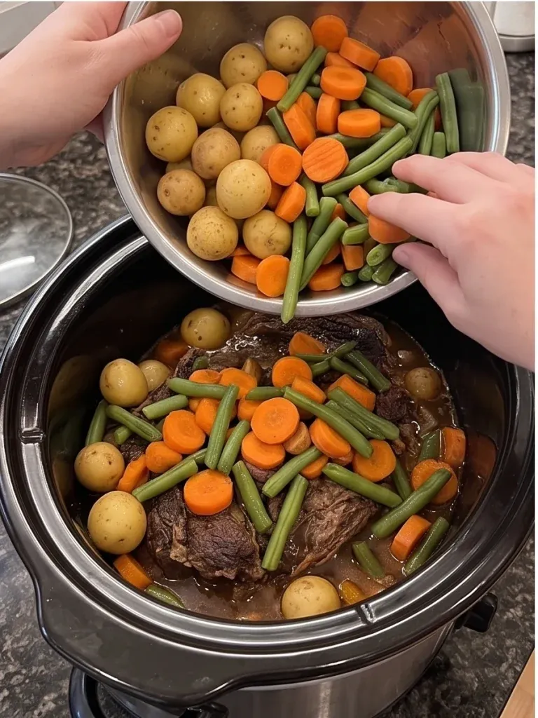 Adding carrots, potatoes, and green beans to a slow cooker pot roast - photo 3